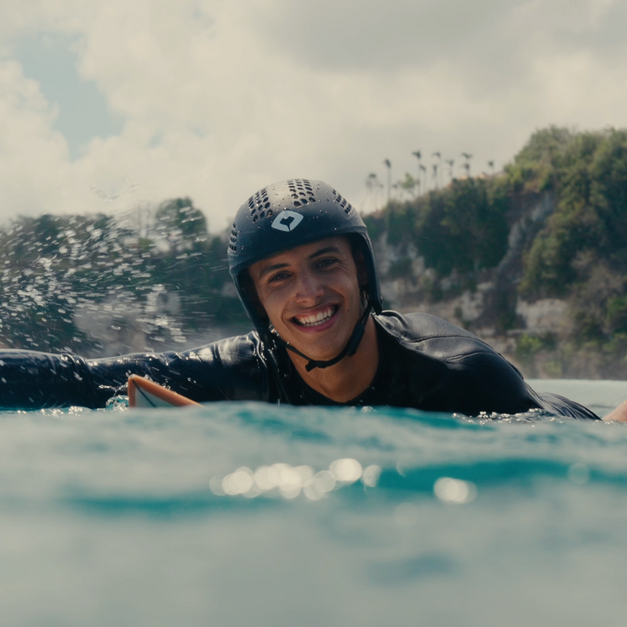 Founder smiling in the water wearing the Mamuli-Surf helmet